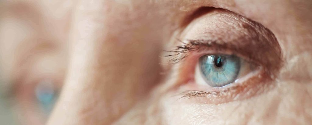 Close-up of an older adult's upper eyelid, brow and lashes