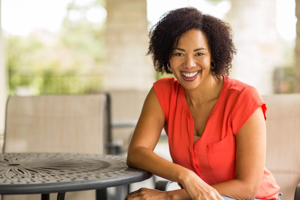 Smiling woman outdoors protecting her vision from diabetes