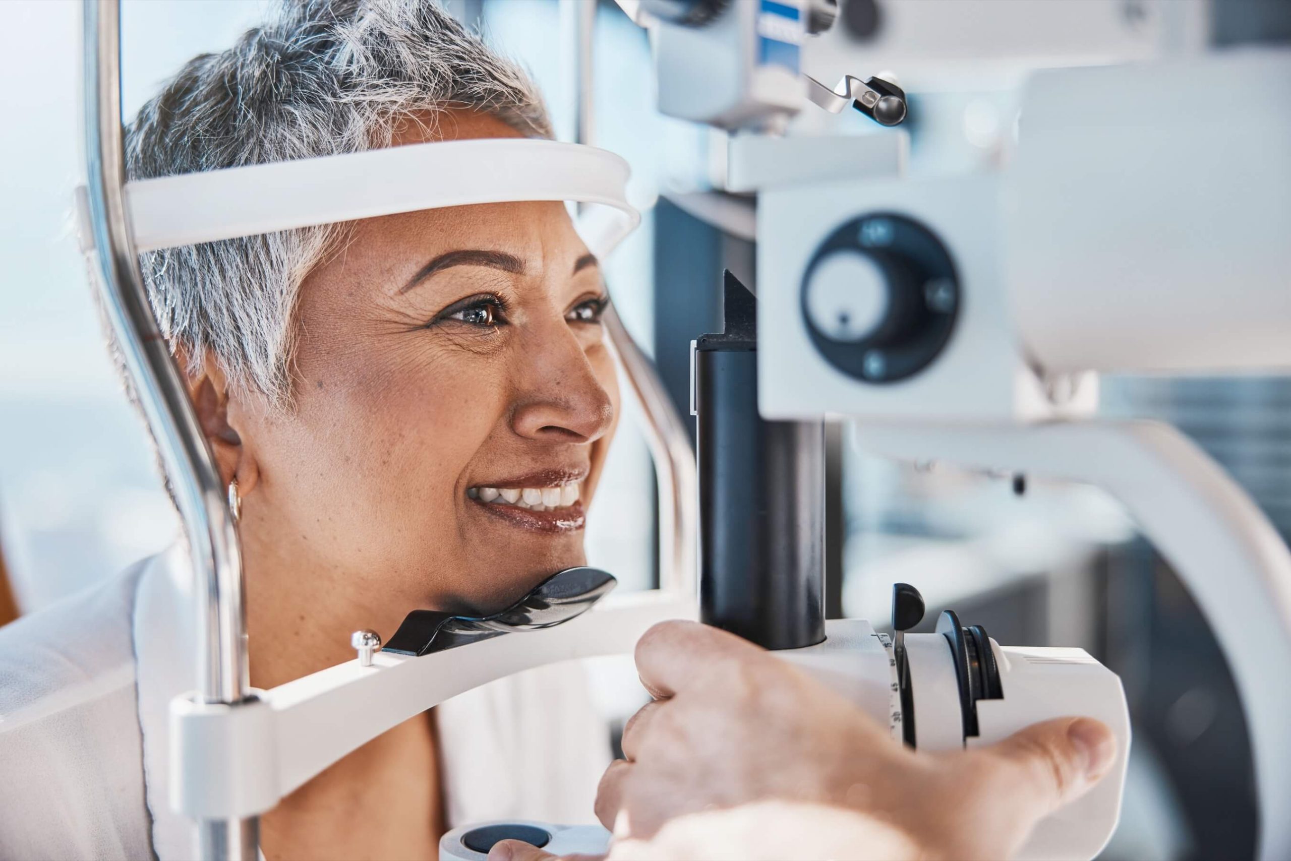 Woman having her eyes examined with a slit lamp